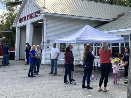 A dozen or so residents stand outside the Vienna Fire department for an event