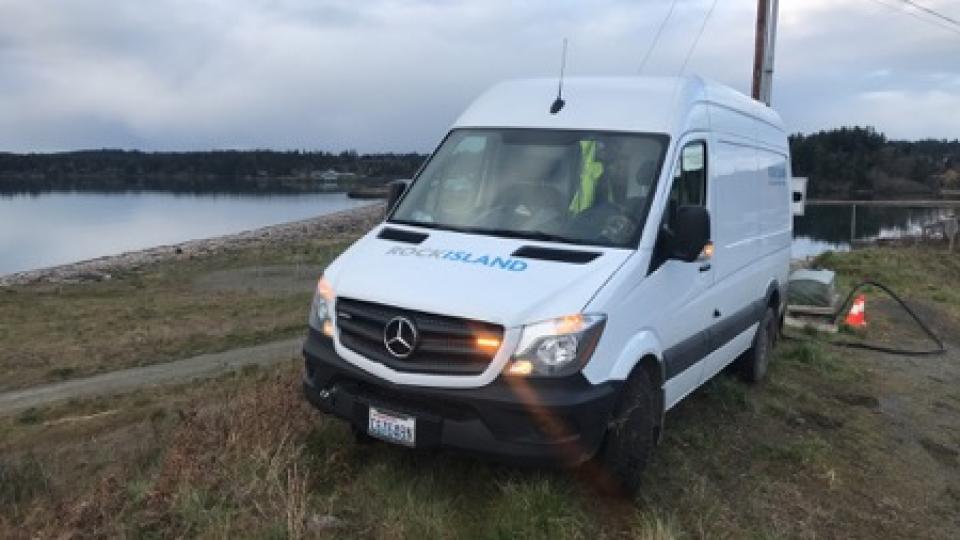 Rock Island Communications service truck parked on grass